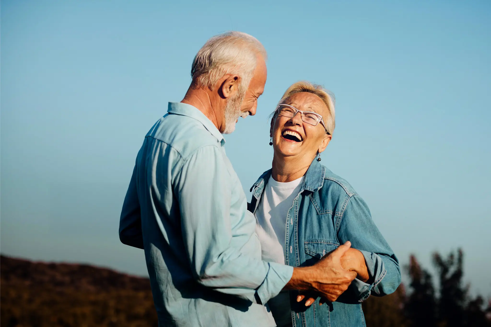 An older couple laughing.